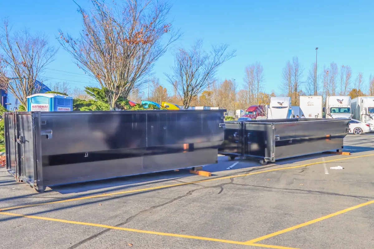 Professional dumpster rental service with roll-off container on residential driveway in Baytown